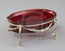 A 19th century continental silver gilt oval stand with ruby glass bowl, with beaded border and