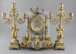 A third quarter of the 19th century French champlevé enamel and ormolu clock garniture, the two