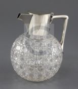 A late Victorian silver mounted cut glass claret jug by Hukin & Heath, in the manner of
