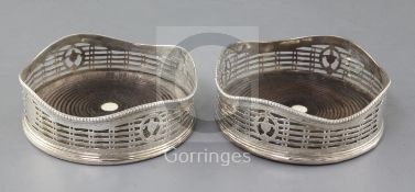 A pair of George III pierced and engraved silver wine coasters by Hester Bateman, with beaded wavy