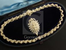 A cased Victorian mother of pearl and seed pearl set pendant necklace with 9ct gold mount, and a