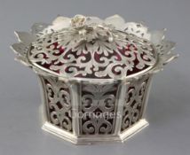 An early Victorian pierced silver bowl and cover with cranberry glass liner, with flared border,