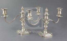 A pair of 1970's silver two branch three light dwarf candelabra, by Barker Ellis Silver Co, with