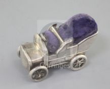 A rare Edwardian novelty silver pin cushion modelled as a vintage car, with rotating wheels, by Levi