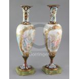 A pair of French champlevé enamel and porcelain vases decorated with panels of Venus and Cupid