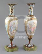 A pair of French champlevé enamel and porcelain vases decorated with panels of Venus and Cupid