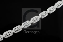 An Art Deco style 18ct white gold and diamond set octagonal link bracelet, 18.5cm.