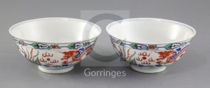 A pair of Chinese doucai 'dragon' bowls, late 19th/early 20th century, each painted with dragons and