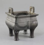 A Chinese bronze fang ding censer, Qing dynasty, with moulded girdle and a pair of high looped