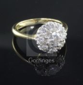 An 18ct gold and diamond cluster ring, the central stone weighing approximately 0.55-0.60cts, size