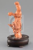 A Chinese carved coral figure of a lady, mid 20th century, wearing flowing robes and holding a