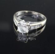 A modern 18ct white gold and single stone radiant? cut diamond ring, with diamond set shoulders,