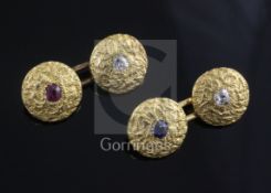 A pair of 18ct yellow textured gold cufflinks set diamond, ruby and sapphire, gross 9.3 grams.