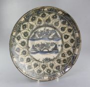 A Safavid stone paste 'Islands' dish, 17th century, painted in Swatow style with islands to the