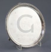 A George III silver circular waiter, Elizabeth Jones, with engraved armorial and beaded border, on