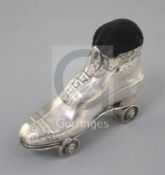 An Edwardian novelty silver roller skate pin cushion on rotating wheels, by Crisford and Norris,