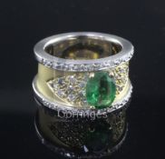 A modern 18ct two colour gold, green garnet and diamond set dress ring, size L.