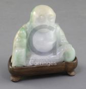 A Chinese jadeite seated figure of Budai, the ice white stone with creamy and apple green