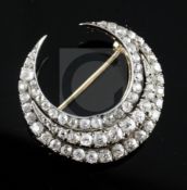 An early 20th century gold and silver, triple row diamond set crescent pendant brooch, with S.J.