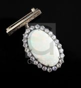 An early 20th century gold, white opal and white sapphire set oval pendant, with bar brooch