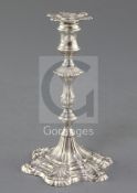 A George III cast silver taperstick by Ebenezer Coker, with engraved crest and waisted knopped