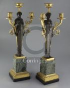 A pair of 19th century French bronze and ormolu three light candelabra, modelled as classical