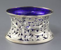 An Edwardian repousse silver dish ring by Williams Birmingham, Ltd, with blue glass liner and