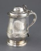 A late George II silver tankard by Samuel Wood, with open work thumbpiece, engraved crest and lid