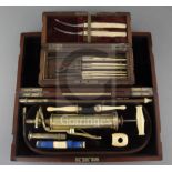 An Evans & Wormull ivory and brass medical pump, in original fitted case, 13in., and a cased set