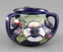 A Moorcroft pansy pattern three handle vase, second quarter 20th century, on a pale green to