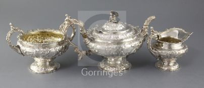 A good George IV silver three piece tea set by John Edward Terry, chased and embossed with