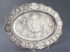 An early 20th century German 800 standard silver oval dish inset with numerous, mainly continental
