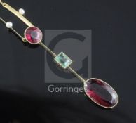 An Edwardian 15ct gold, deep pink tourmaline, emerald and seed pearl drop pendant necklace, drop