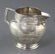 An Edwardian silver jug by Edward Barnard & Sons Ltd, decorated with vineous band and Bacchanalian