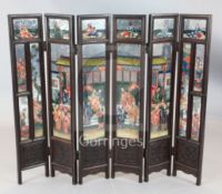 A 19th century Chinese hongmu six fold table screen, inset with mirrored panels painted with figures