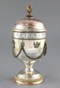 A silver commemorative annular dial timepiece, Mappin and Webb, no.131/210, of urn form with applied