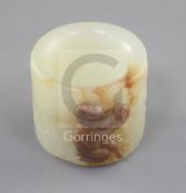 A good Chinese pale celadon and russet jade archer's ring, 18th/19th century, the carver