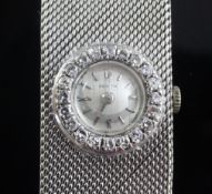 A lady's 18ct white gold and diamond set Zenith manual wind bracelet watch, with baton numerals