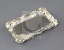 A 1930's Omar Ramsden silver shaped rectangular pin dish, with flower head decorated angles, London,