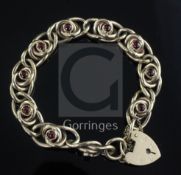 A 9ct gold and cabochon garnet set bracelet, with heart shaped clasp.