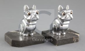 H. Moreau. A pair of Art Deco spelter bookends, modelled as a seated French Bulldog, with glass