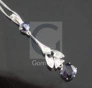A platinum? sapphire and diamond drop pendant, set with cushion and round cut sapphires and four