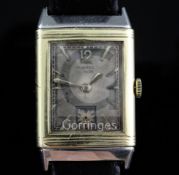 A 1930's 18ct gold and stainless steel Le Coultre Reverso manual wind wrist watch, the rectangular