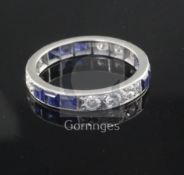 A 1940's/1950's platinum? sapphire and diamond set full eternity ring, with three stone