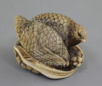 A Japanese ivory netsuke of two quails, 19th century, each seated upon millet, engraved five