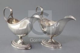 A pair of late 18th/early 19th century Belgian? silver pedestal sauce boats, with panelled bodies,