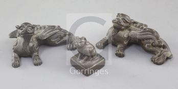 A pair of Chinese bronze mythical beast scroll weights and a similar seal, 18th/19th century, 6.