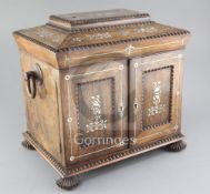 A mid 19th century mother of pearl inlaid rosewood toiletry box, the sarcophagus top and doors