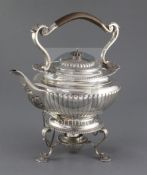 An Edwardian demi-fluted silver tea kettle on stand, with burner, by Edward Barnard & Sons Ltd, on