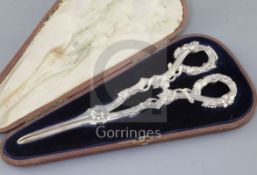 A cased pair of Victorian cast silver grape shears by Francis Higgins II, with reeded vineous